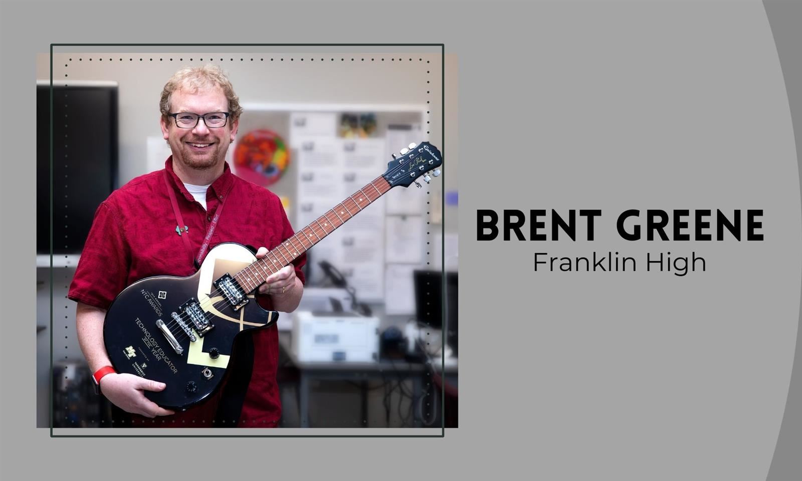 Brent Greene holds a guitar 